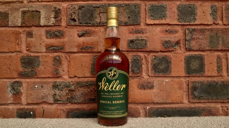 A bottle of Weller Special Reserve posed in front of a red brick background