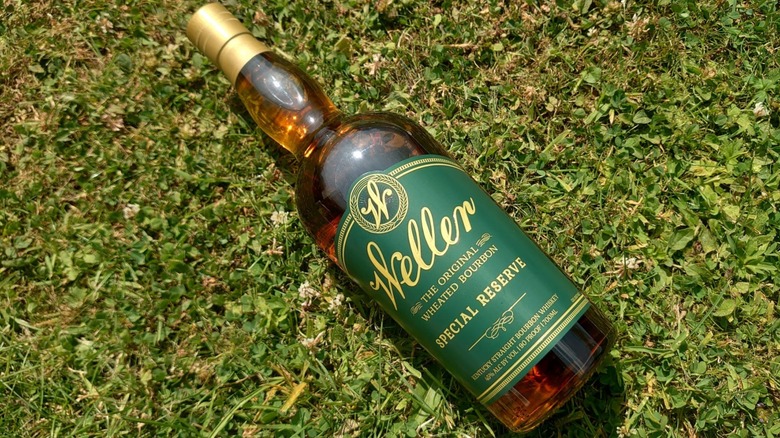 An overhead shot of a bottle of Weller Special Reserve laid diagonally on the grass