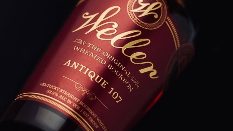 A close up of the label of Weller Antique 107 with a dark background