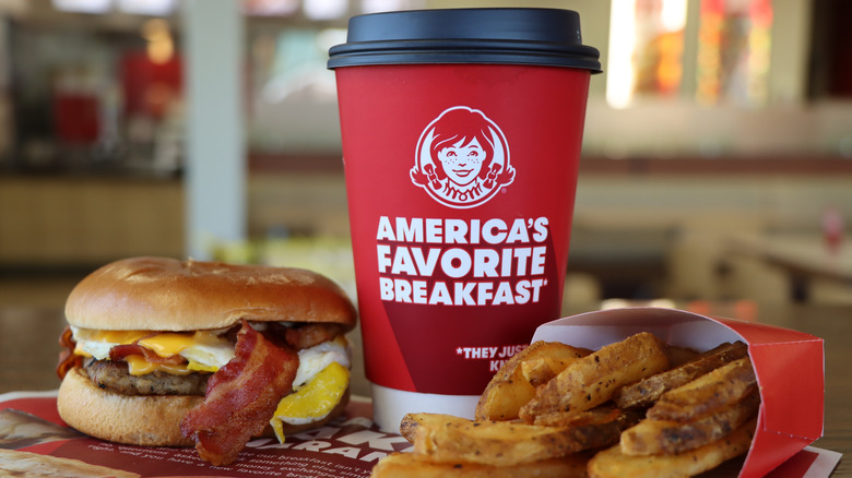 Wendy's breakfast sandwich, french fries, and branded coffee cup
