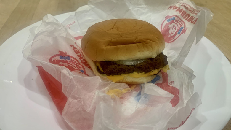 Double Stack burger on top of paper wrapper on white plate