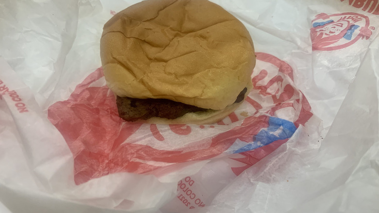 Jr.Cheeseburger on top of paper wrapper on white plate