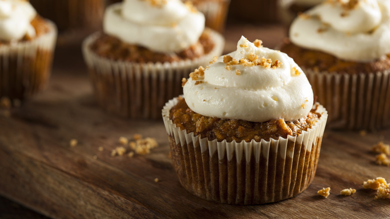 Carrot cake cupcake with walnut topping and white icing