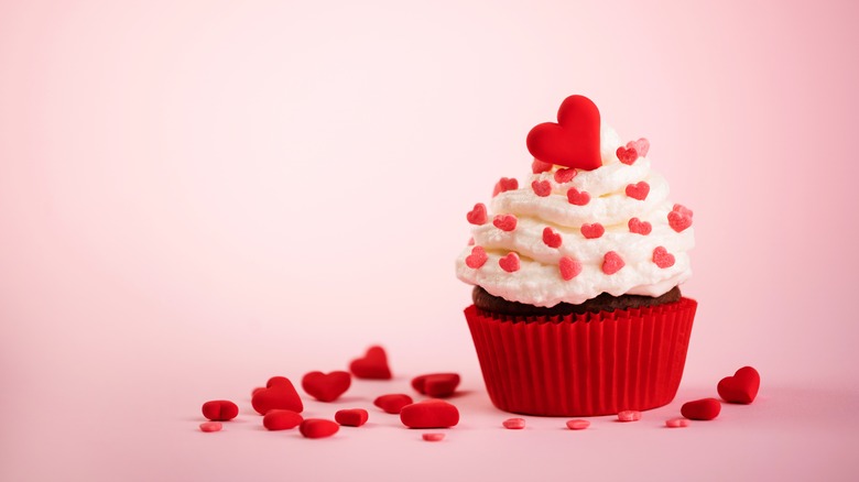 Cupcake with lots of icing and heart sprinkles