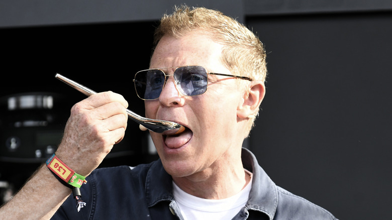 Bobby Flay putting spoon to his mouth