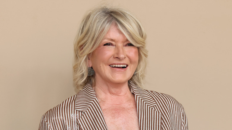 Martha Stewart smiling while looking on