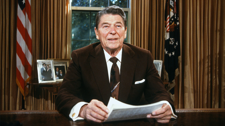 Ronald Reagan sitting at desk