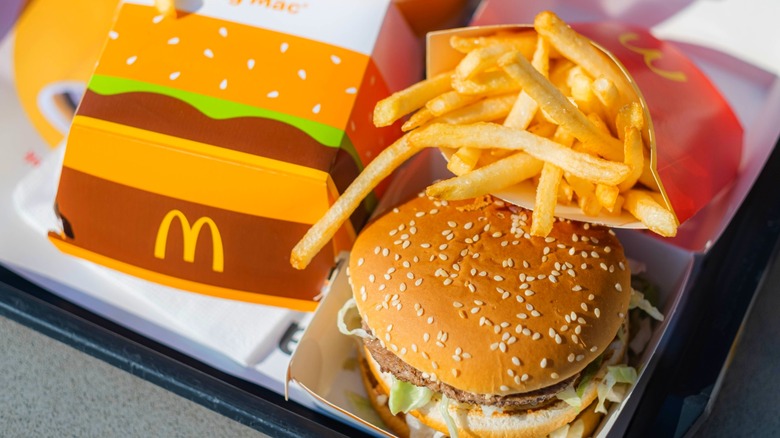 McDonald's Big Mac burger on black tray with french fries