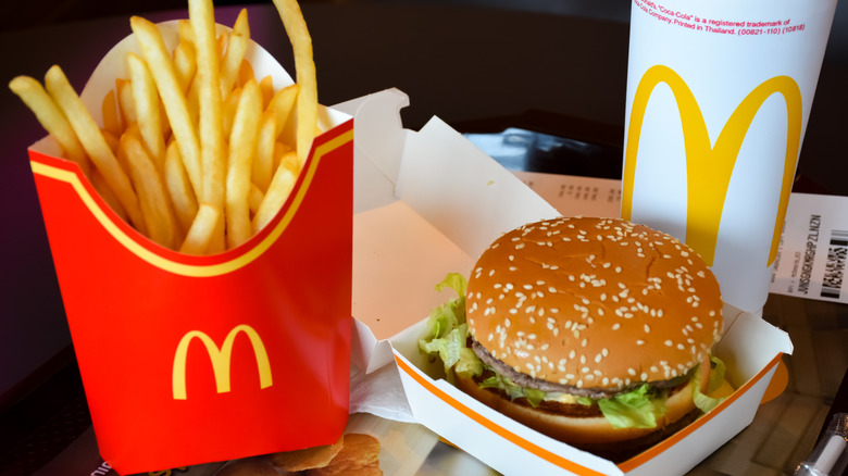 McDonald's Big Mac meal with red cardboard box of fries, drink cup, and burger in paper box