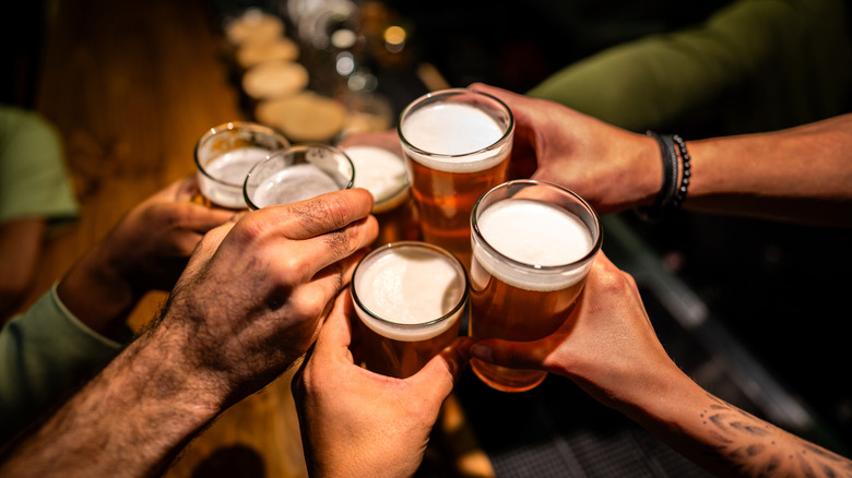 Hands holding beers for a toast