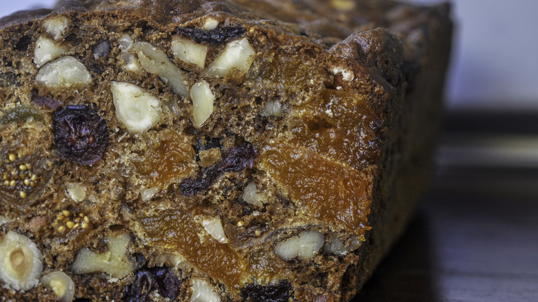 Cross section of fruit cake showing various nuts and dried fruits