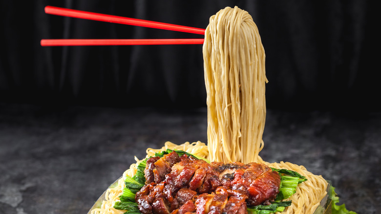 floating noodles with red chopsticks