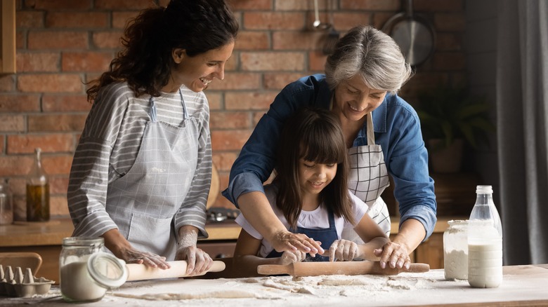 Generations making biscuits in kitchen 