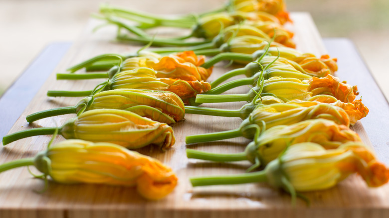 squash blossoms on a cutting board