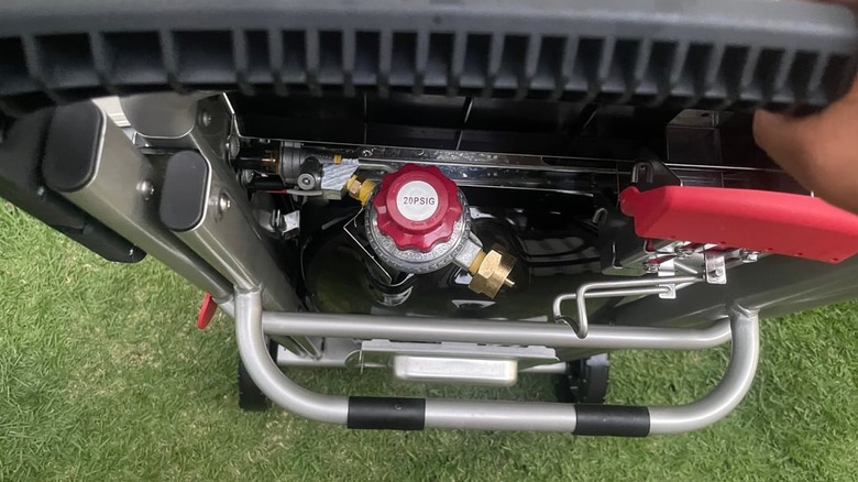 An overhead view of the gas regulator assembly in a portable Weber grill