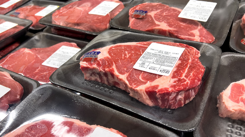 Grocery store display of raw USDA Choice steaks