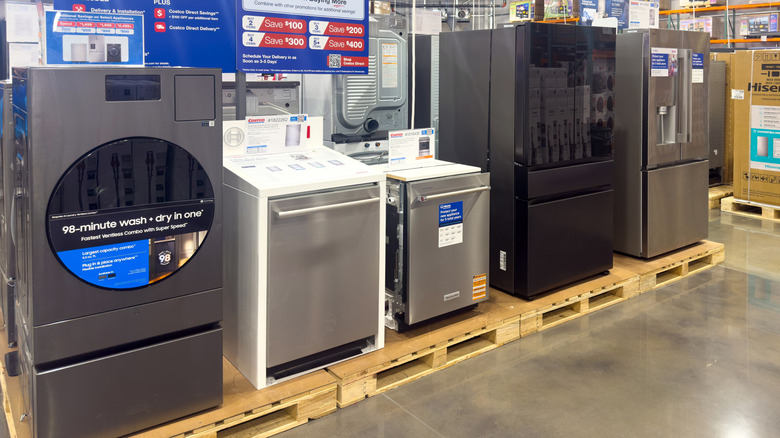 A row of kitchen appliances on pallets in a Costco Wholesale store