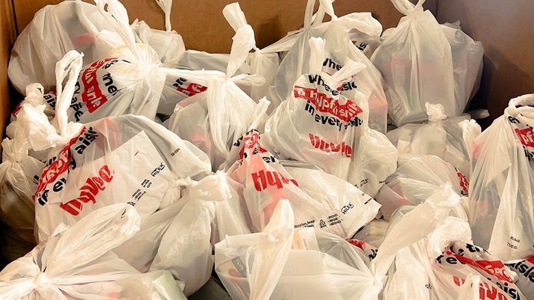 Hy-Vee plastic bags filled with food in a cardboard box