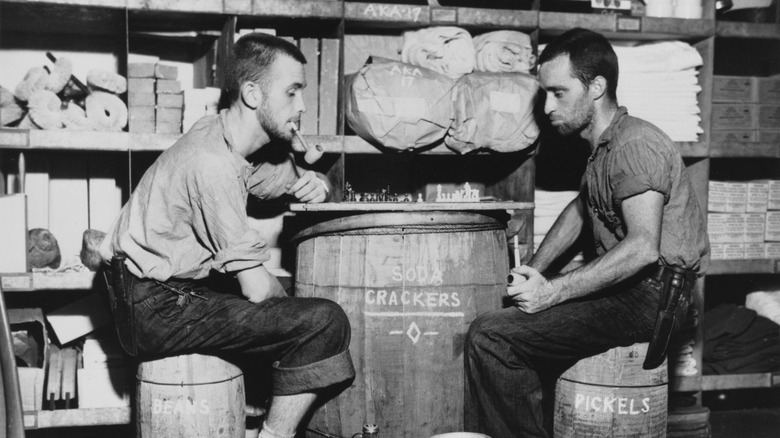 men playing checker on barrel