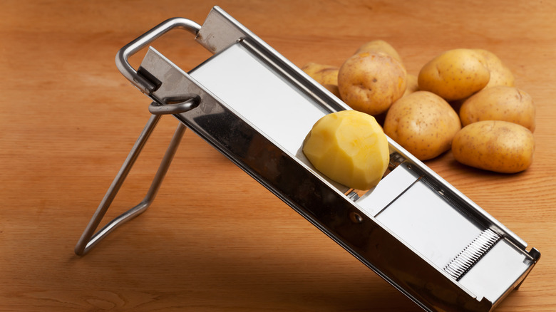 Slicing a potato on mandoline