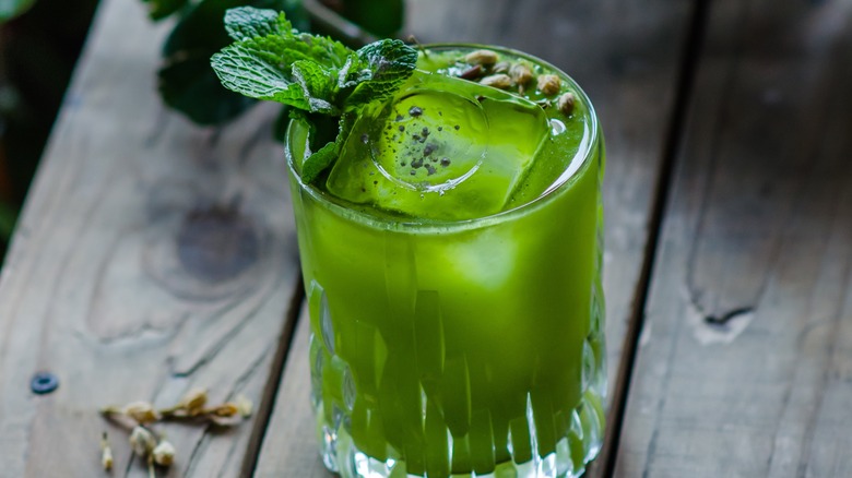 green cocktail garnished with mint