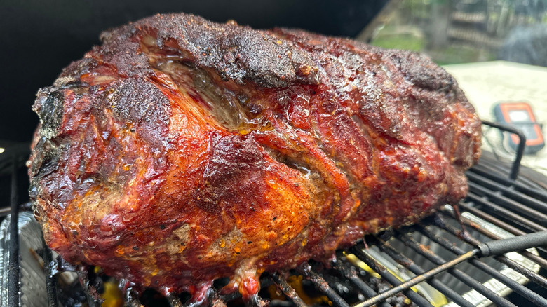 Bone-in pork shoulder being smoked