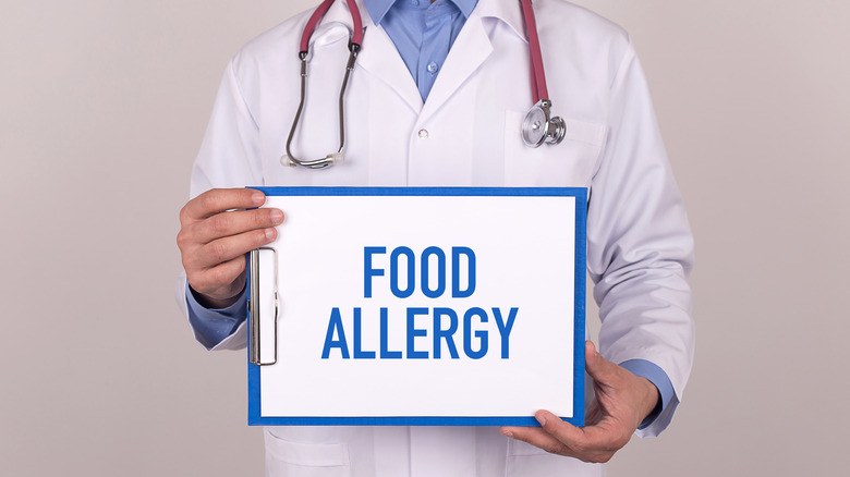 doctor holding food allergy sign