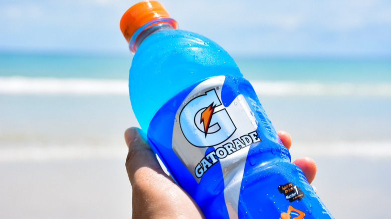 person holding a blue Gatorade bottle