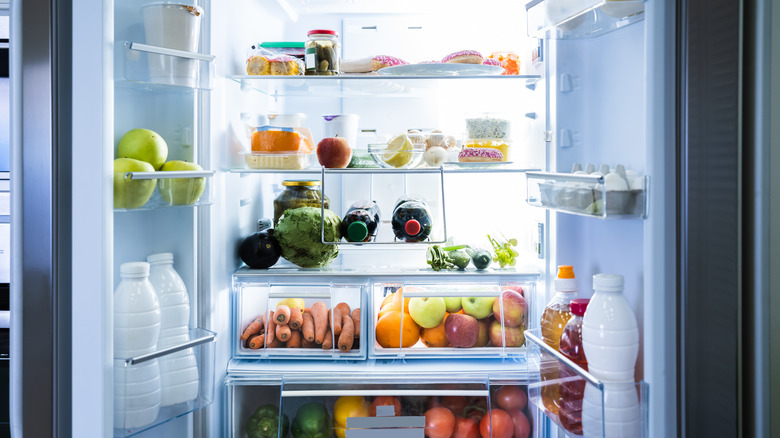 open refrigerator filled with fruits and vegetables