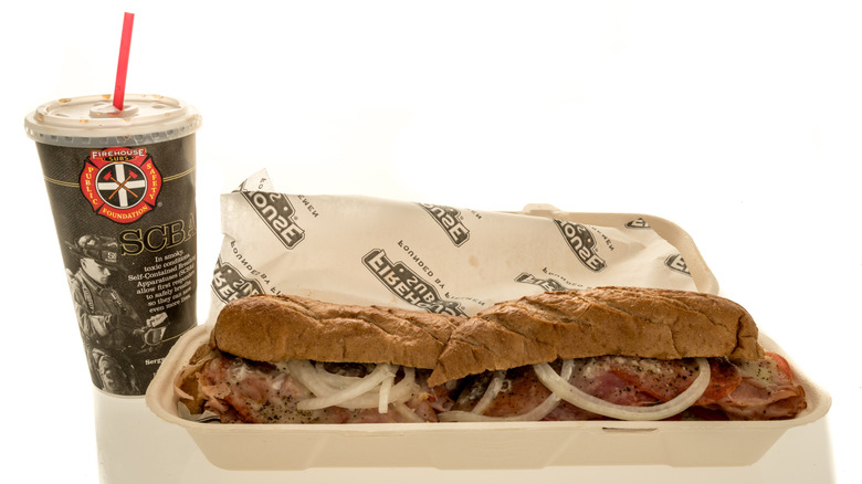 Firehouse Subs meal with sandwich in take-out box next to a drink