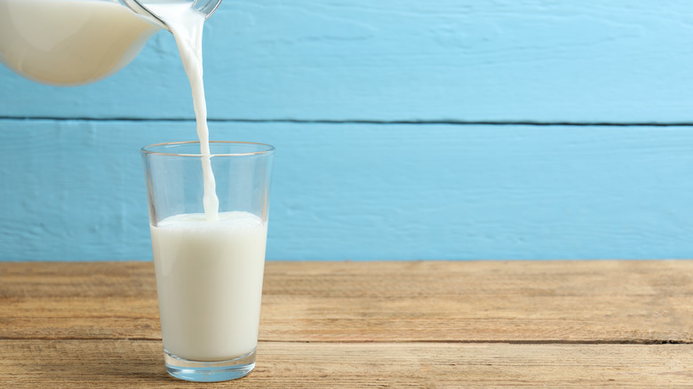 Pouring milk from jug into glass