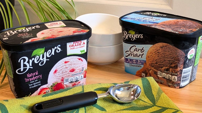 Tubs of Breyers ice cream with bowls and scooper