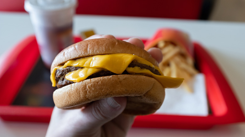 Fast food hamburger in hand