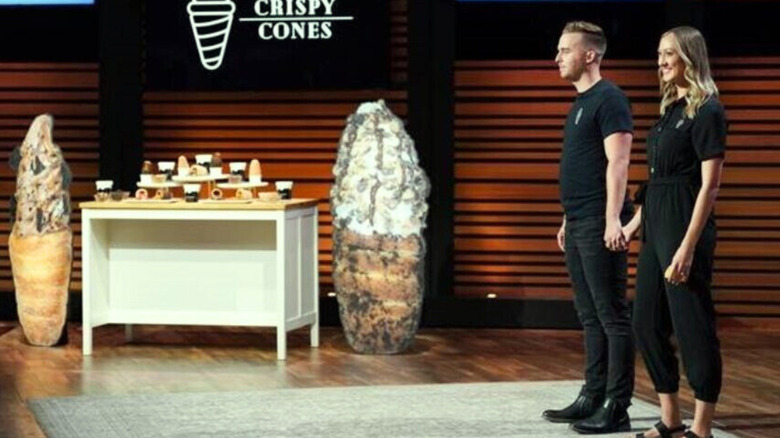Jeremy and Kaitlyn holding hands beside ice cream display on "Shark Tank"