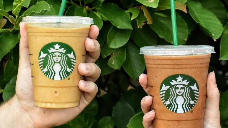 Hands holding both varieties of Starbucks Protein Blended Cold Brews