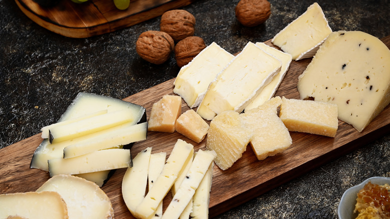 different cheeses stacked on board