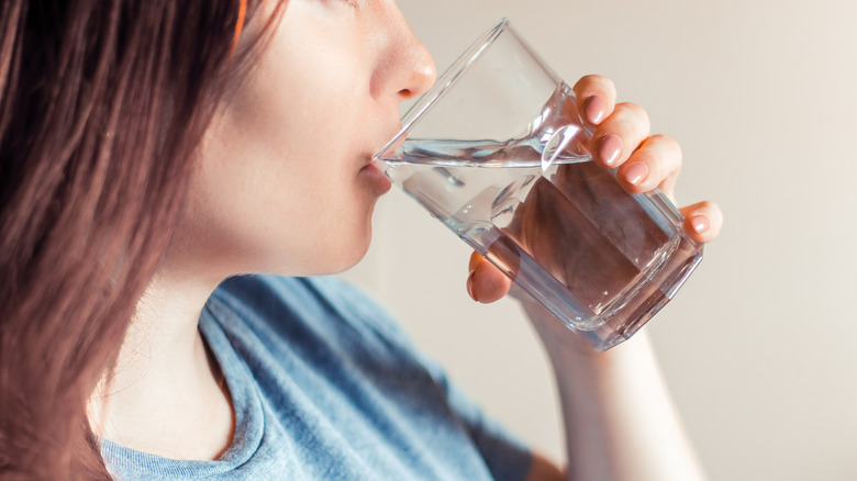 close-up of a woman drinking water out of a glass