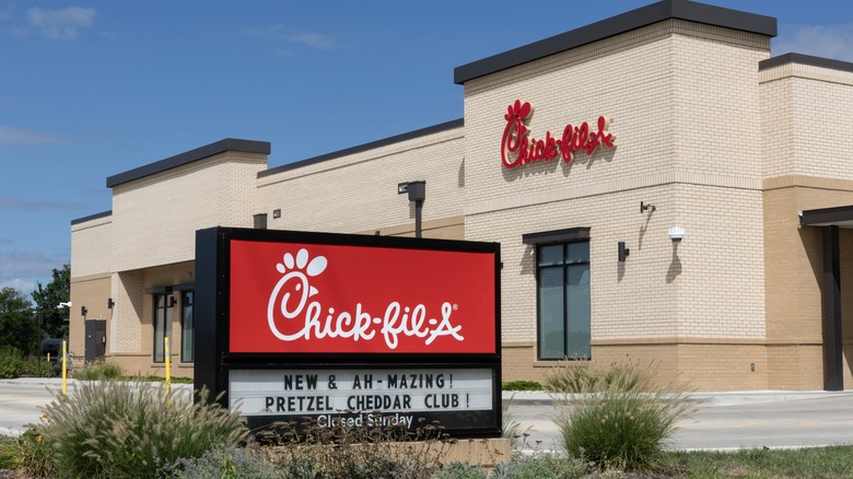 A Chick-fil-A sign in front of the restaurant during the day