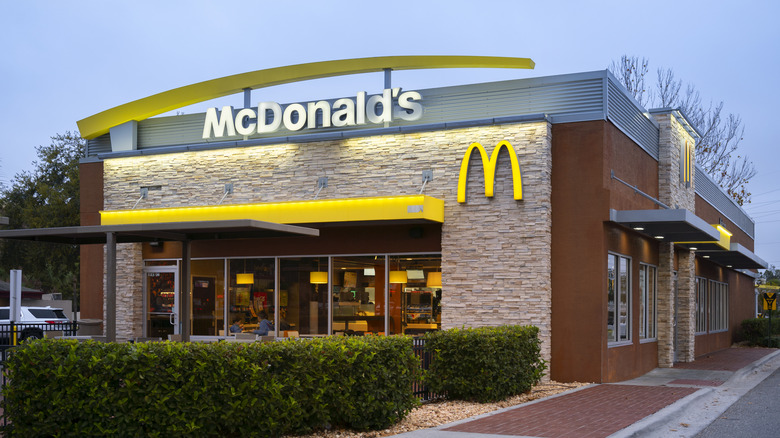 A McDonald's location with a drive-thru at dusk