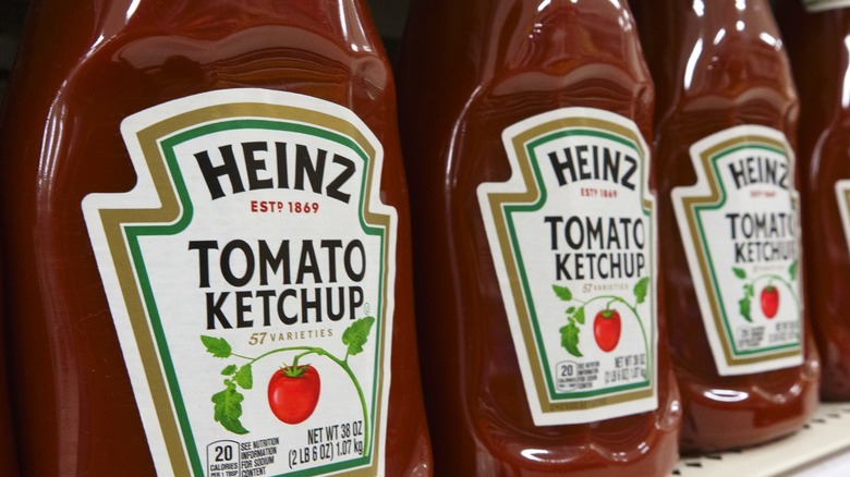 Large bottles of Heinz tomato ketchup on a shelf at the grocery store