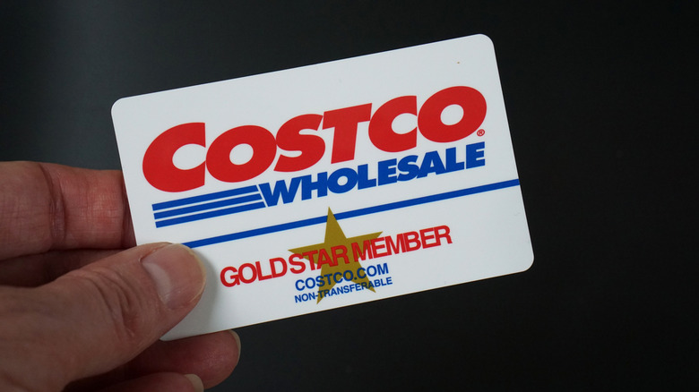 Close-up of hand holding a Gold Star Costco membership card