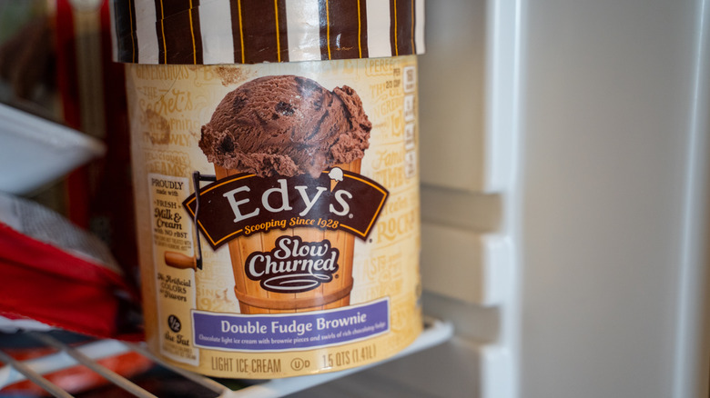 A container of Ediy's slow Cher and double French brownie light ice cream