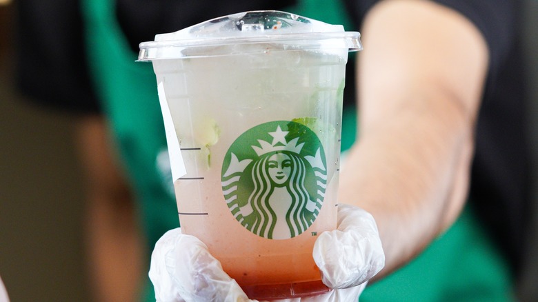 Starbucks barista serving drink