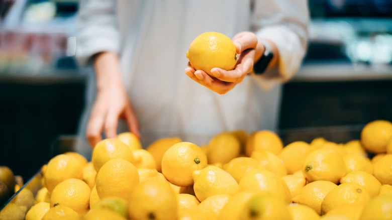 hands sorting through lemons