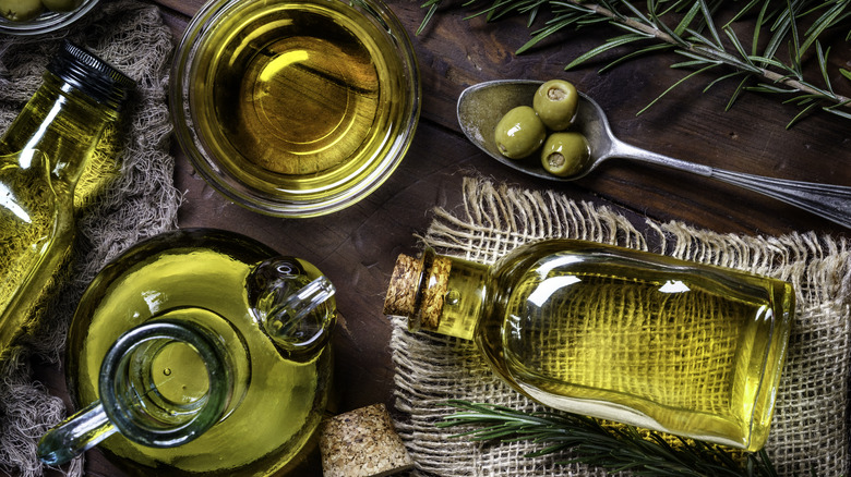 Olive oil bottle with olives and bowl 