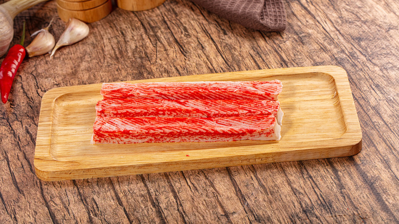 Imitation crab on wooden board