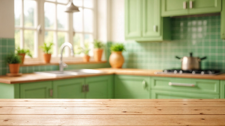 View of kitchen with wood counters, green walls