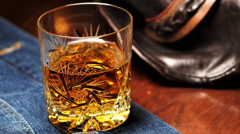 A glass of bourbon on table