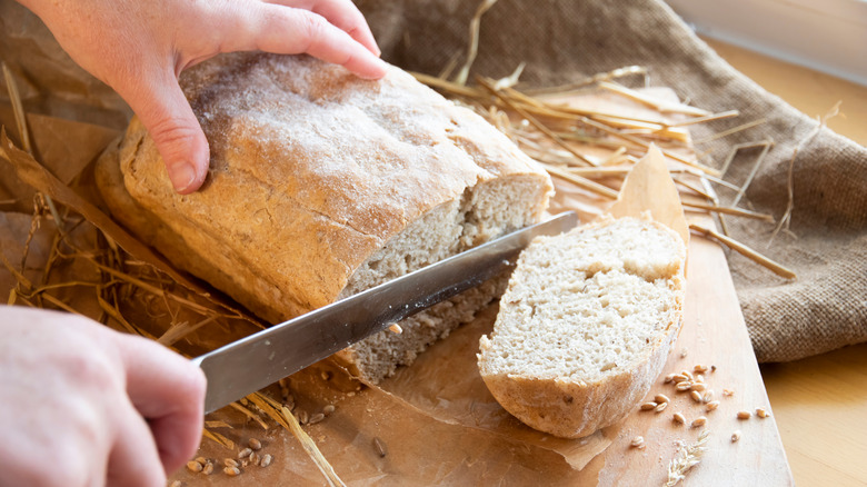 cutting bread with knife