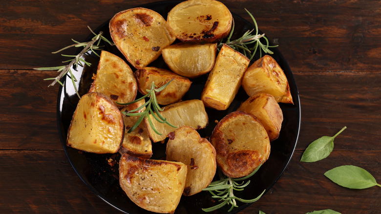 A plate of perfect roast potatoes with rosemary